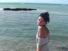 Foxy brunette girl Bella Margo is posing naked on the beach