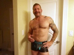 Unshaved beefcake Colby Jansen flaunts his huge dildo collection