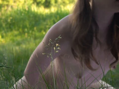 Flika Luchik is playing with her pussy in an open field