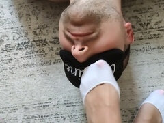 Sniffing a young European amateur's sweaty feet in white socks