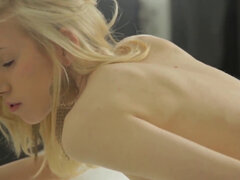 Slender blonde with a pefect figure all alone on the couch