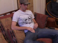 While watching a porn video, Gabriel Turner gets himself hard and then lubes his stiff dick for self-pleasuring.