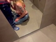 Stepmom joins her horny stepson in the cinema bathroom to help him release his big build, flashes him and sucks his cock