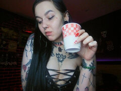 Sexy Alternative Brunette Drinking Sparkling Water and Burping