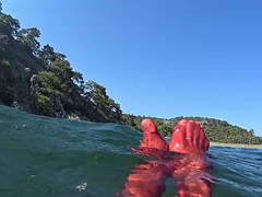 Red stocking in the sea on a public beach