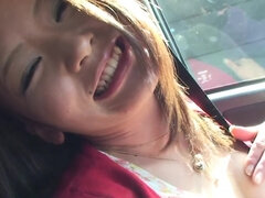Horny Japanese girl is showing her lovely titties in the car