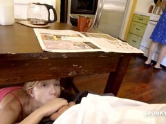 Daughter sneaks under the table to suck daddy's cock