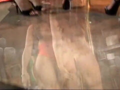 Lusty brunette is held in stripper basement for titty licking