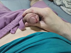 A guy in purple shorts jerks his dick