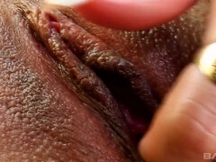 See Susan Pearl wrap her pussy lips around a black and white dildo