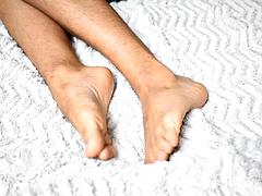 Delicious feet on a beautiful white sheet