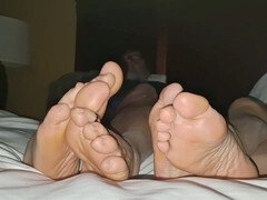 Massaging our feet while chilling in our motel room and watching TV