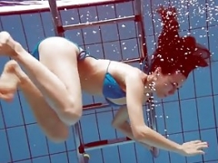 Redhead in blue bikini showing her body