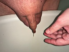 Pissing, playing with my little foreskin dick