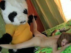 A dude in a panda outfit is having his way with a young woman