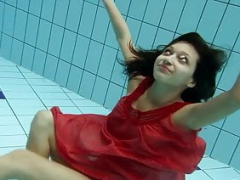 Sexy brunette Anna in red dress swimming
