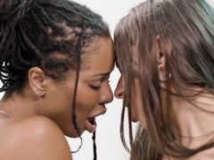 Kira Noir and April Olsen in interracial lesbian scissoring video