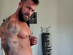 OF - Gareth Hulin, a tattooed and muscular bodybuilder, shows off