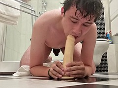 Guy deep throats a dildo fresh out of the shower