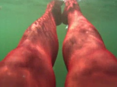 Red stocking in the sea on a public beach