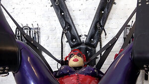 Sissy is bound in latex bondage and punished by dominatrix