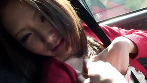Horny Japanese girl is showing her lovely titties in the car