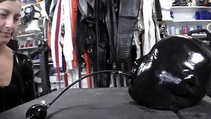 Gimp in tight latex bondage is tortured by a dirty mistress