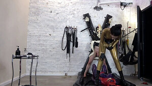 Latex clad clown show ends up with some CBT for Rubbertoy