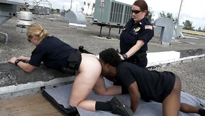 Black stud and two female cops are fucking on the roof