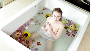 Scarlett Sage satisfies pussy in the bathtub with flowers