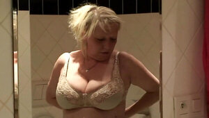 Mature woman with massive boobs giving a titjob after shower