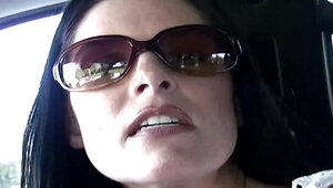 Hot raven-haired milf in sunglasses gives head in the car