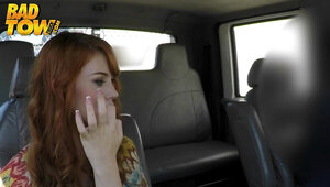 A redhead is in the car where she is sucking a hard large cick