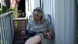 The blonde granny relaxing on the porch and gives a blowjob