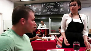 Excited college couple copulates on the table in canteen