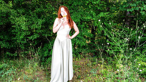 Pale redhead with perfect curves is naked in nature