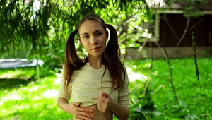 Pigtailed teen Nicole Heavens teasing her tight hole
