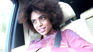 Curly Ebony girl welcomes white dude's rod in a car after a trip