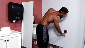 Black lad is sucking and fucking through the glory hole
