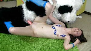 A teen brunette is getting fucked by a guy wearing a panda suit