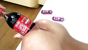 Massive cola bottle is penetrating the asshole of a busty slut