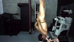 Submissive man is tied up and two chicks toy with him