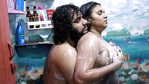 Chesty brunette getting wet in the shower with her man