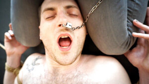 German woman and a submissive man making a BDSM tape