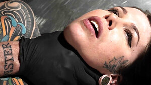 Tattooed girl is bound and fingered in BDSM dungeon