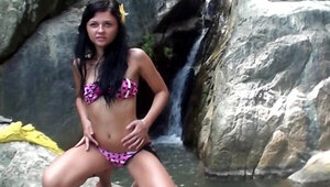 Foxy brunette girl Bella Margois flashign pussy by the waterfall