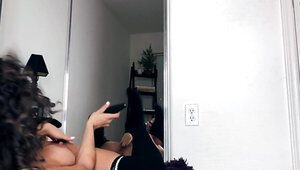 Curly-haired beauty is masturbating in front of the mirror