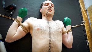 German woman and a submissive man making a BDSM tape