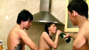 Three teenagers are fooling around in the kitchen with their female friend