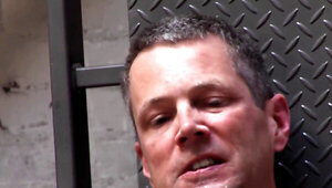 Thick redhead in a sexy suit plays with a submissive fellow